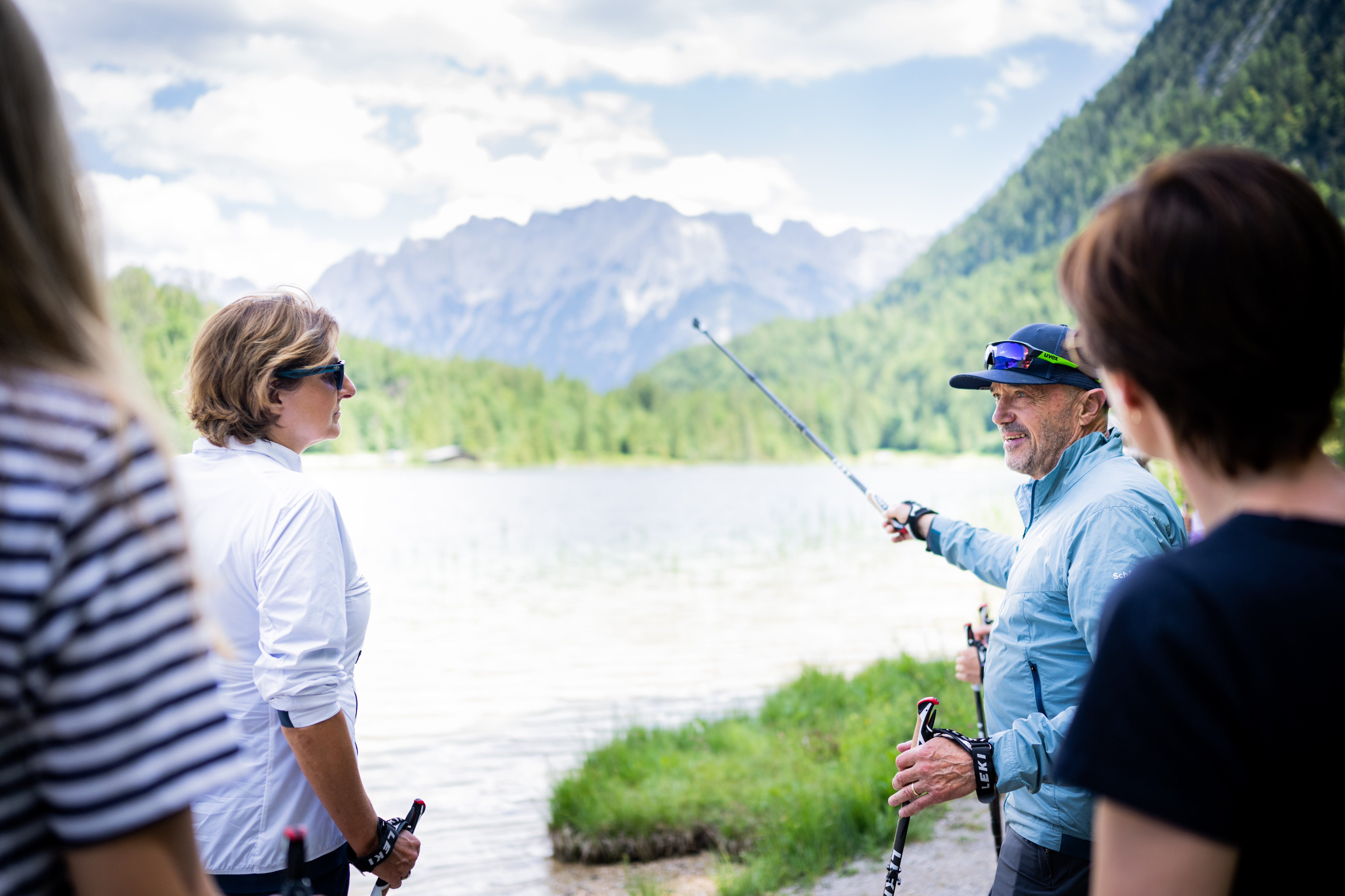 Christian Neureuther (at right) talks to Britta Ernst (at left) during a Nordic walking tour along the banks of the Ferchensee.