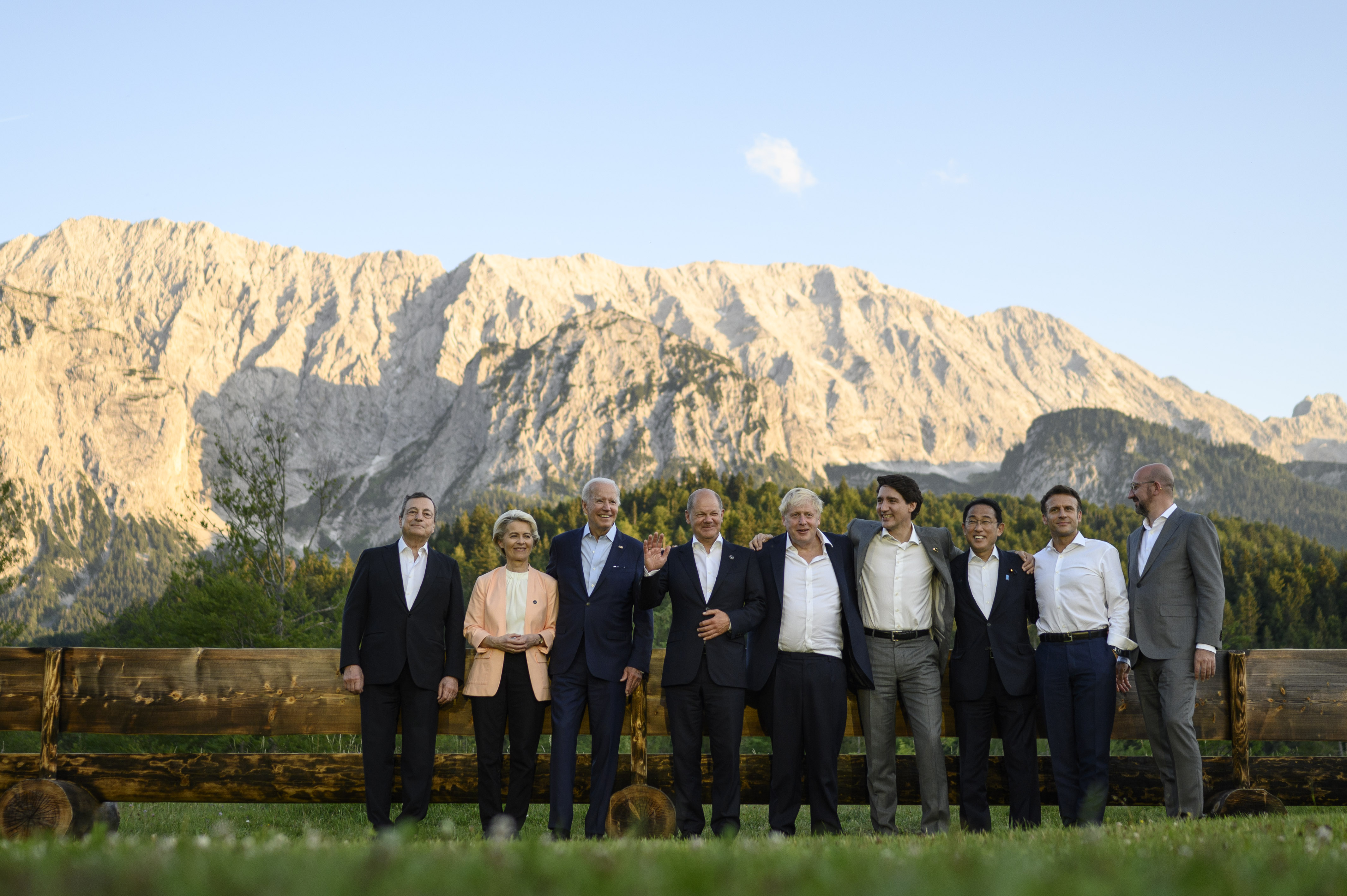 Group photo of G7 participants with the mountains in the background.