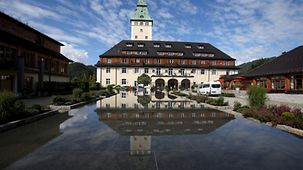 Outdoor shot of Schloss Elmau with a reflection in the pond