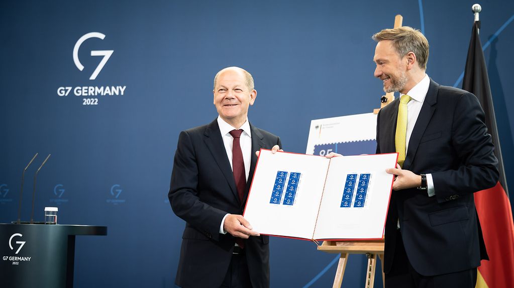Federal Chancellor Olaf Scholz and Christian Lindner, Federal Minister of Finance, present the special postage stamp for the G7 Summit.
