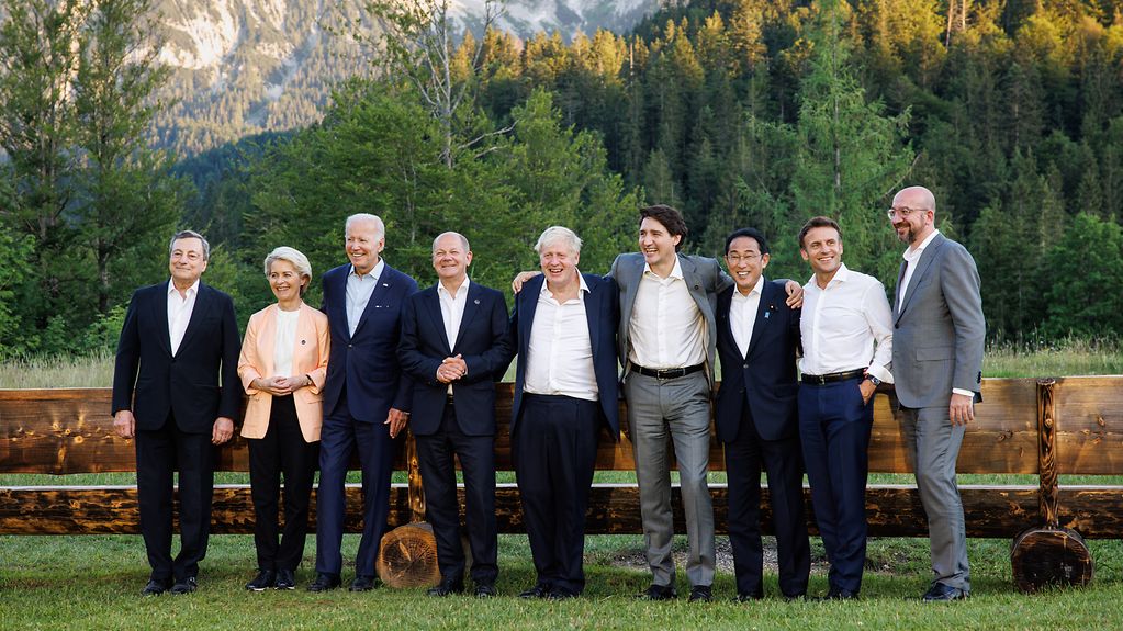 Group photo of G7 participants with the mountains in the background.