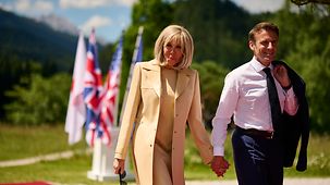 French President Emmanuel Macron and his wife Brigitte make their way to the official welcome to the G7 summit at Schloss Elmau.