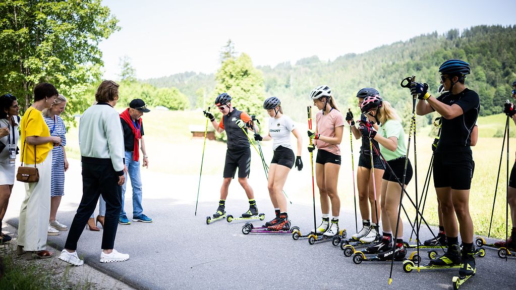 Christian Neureuther und der Olympia-Nachwuchs demonstrieren den G7-Partnerinnen Techniken beim Rollski.