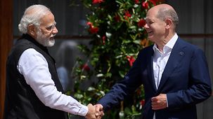 Bundeskanzler Scholz und Premierminister Modi schütteln sich die Hände.