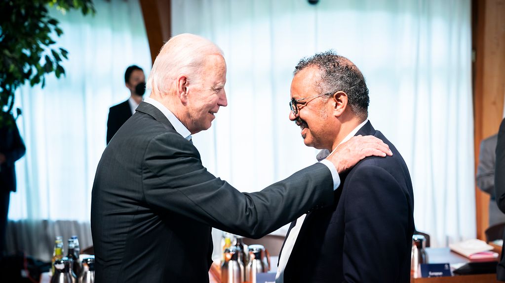 US President Joe Biden in conversation with Tedros Adhanom Ghebreyesus, Director-General of the World Health Organization (WHO), before the sixth working session begins.
